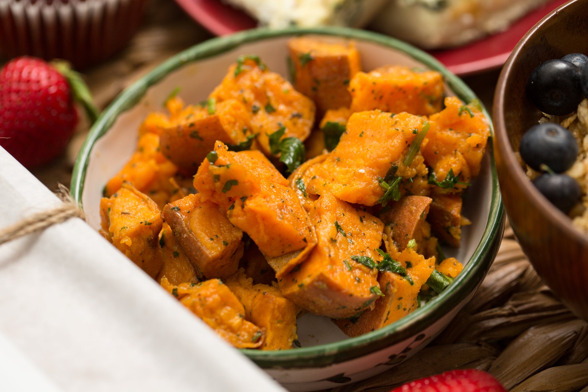 Spiced Sweet Potatoes in a white and green bowl